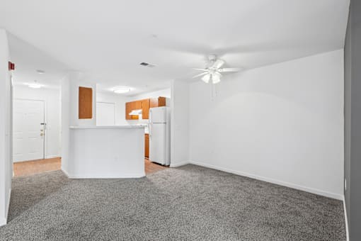 A white reception desk in a room with a grey carpet.