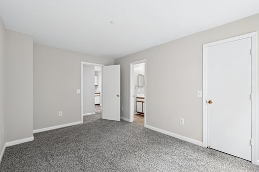 A room with a carpeted floor and white walls.