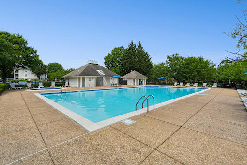 A swimming pool with a gazebo in the background.