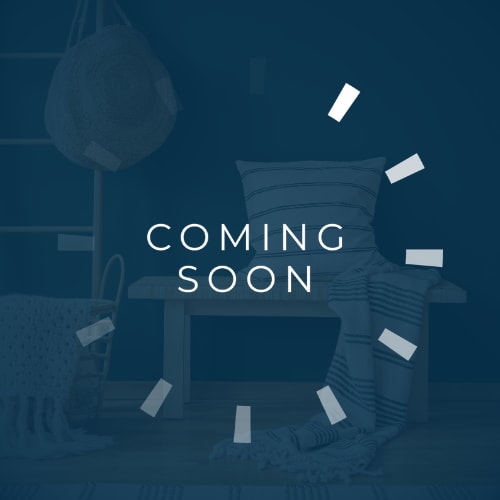 A room with a chair, a sofa, and a lamp with a "Coming Soon" sign.
