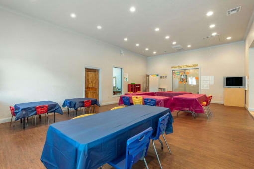 Resident activity room with tables and chairs