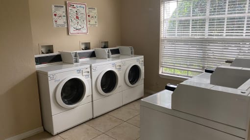 Laundry center with washer and dryers and tile flooring