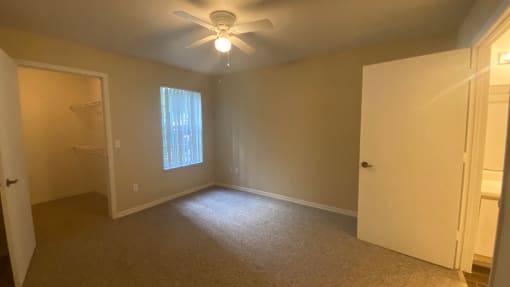 Carpeted Bedroom with ceiling fan and large closet, dual tone paint
