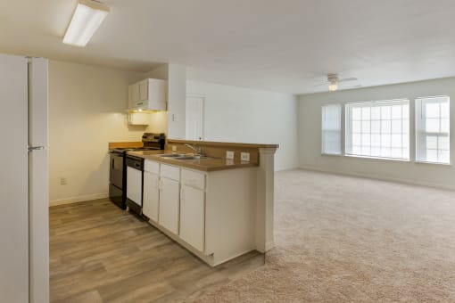 a kitchen and living room with a large window