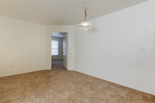 a bedroom with white walls and carpet