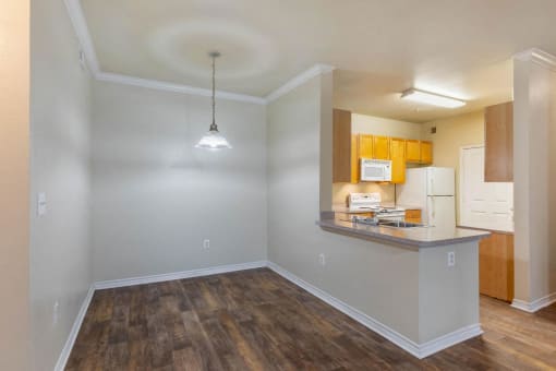 Dining Room with hardwood style flooring, wooden cabinets, and a light fixture