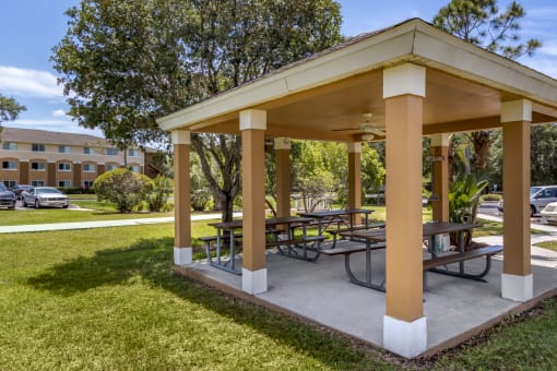 Outdoor covered picnic area surrounded by native landscaping