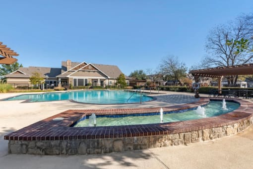 Swimming Pool with Tanning Deck and a fountain alongside the perimeter of the pool