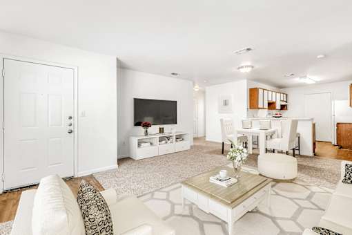living room carpet and the kitchen in the background