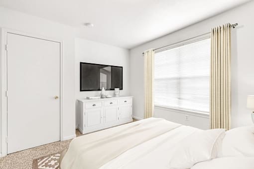 Bedroom with large window dresser with a tv