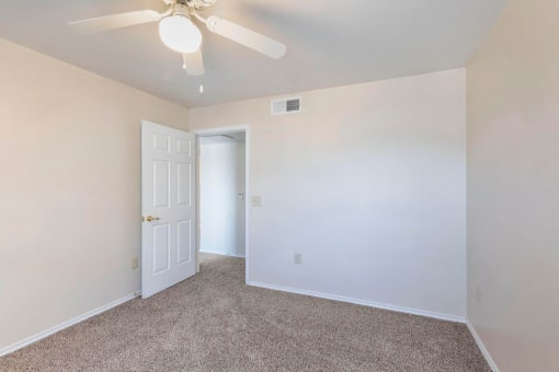 Bedroom with ceiling fan and wall to wall carpet