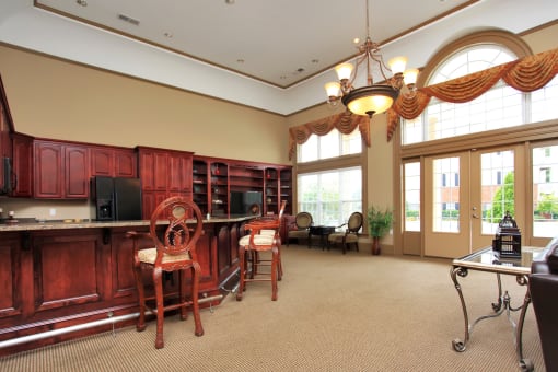 Resident Lounge and Clubhouse Kitchen with Bar stools and French doors leading outside