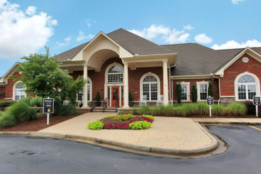 Exterior of leasing office with flower beds