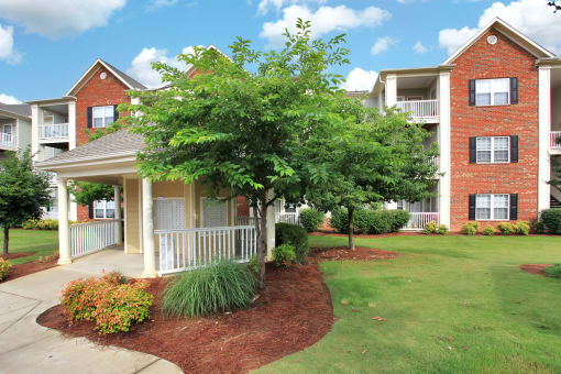 Gazebo with large tree and  the apartment buildings in the background.