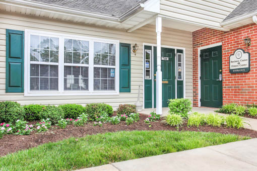 Building Exterior surrounded by shrubbery. Entrance to office