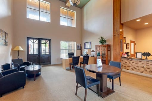 Clubhouse interior with large windows, tables, chairs, and decorations
