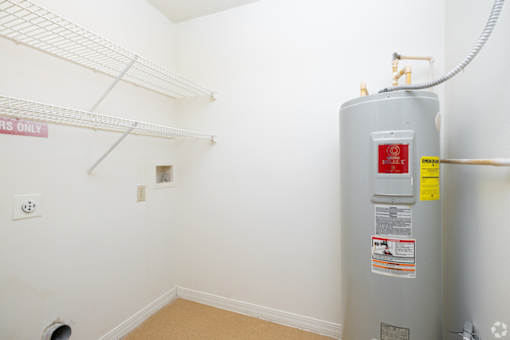 A water heater in a room with a sign that says