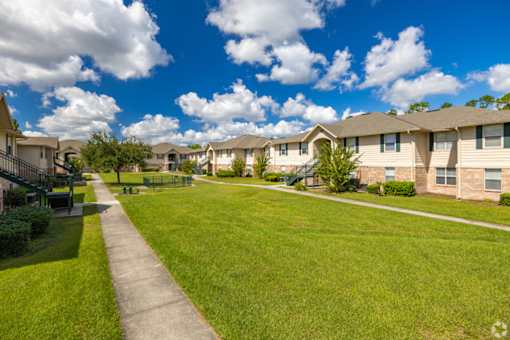 A sunny day at a residential area with houses and a clear blue sky.