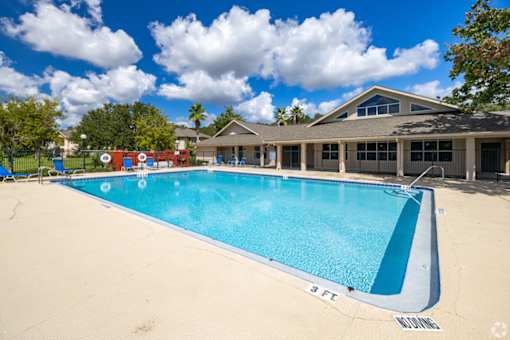 A large outdoor swimming pool with a 3 feet depth marking.
