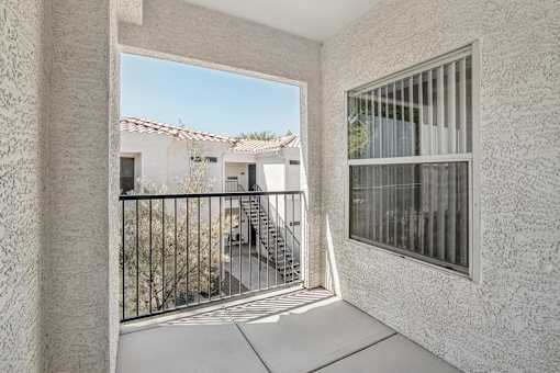 Private balcony with view of adjacent building at Lake Pleasant Village Apartments, Peoria, 85382