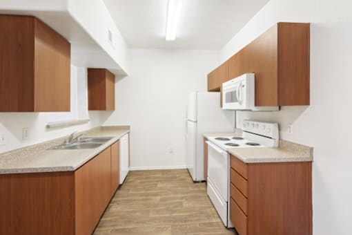 a kitchen with white appliances and wooden cabinets