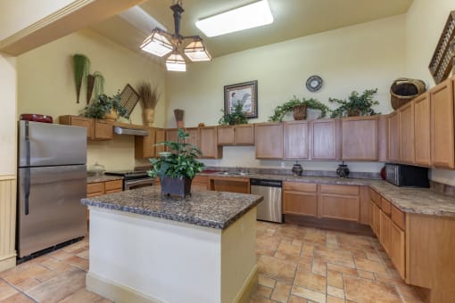 a large kitchen with granite countertops and stainless steel appliances