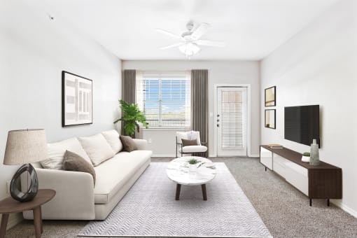 a living room with white walls and carpet