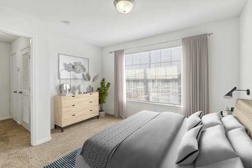 A bedroom with a large bed and a dresser with a mirror.