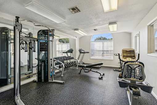 A well-equipped gym with a variety of machines and weights.