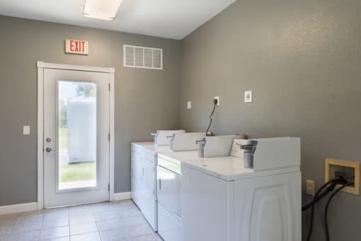 Laundry Facility with Machines Next to Glass Door