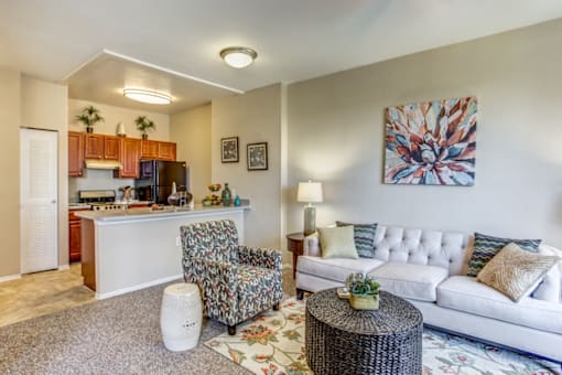 a living room with a couch and a table and a kitchen