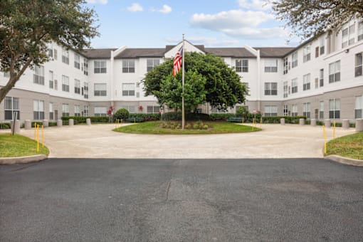 an apartment building with an flag in front of it
