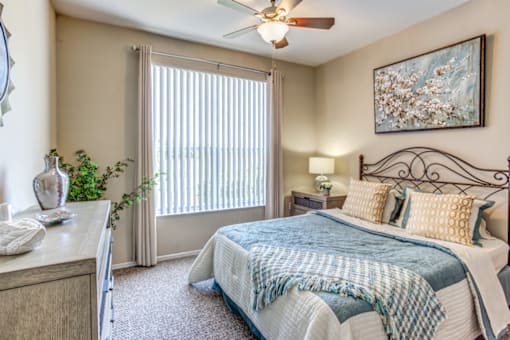 a bedroom with a bed and a ceiling fan