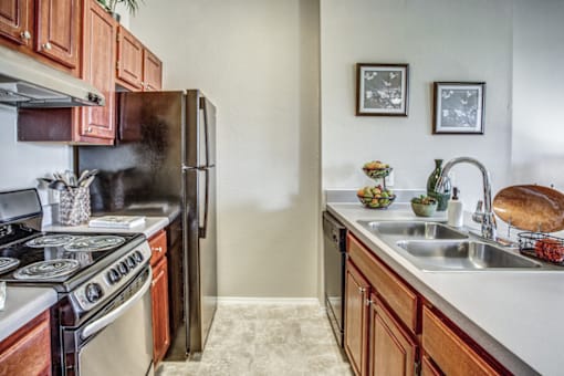a kitchen with a stove sink and refrigerator