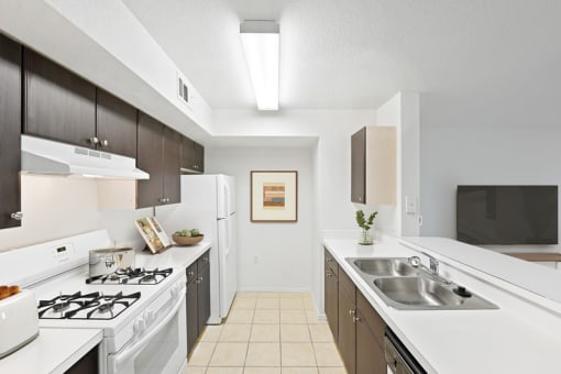 a kitchen with white countertops and a white stove top oven