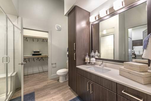 a bathroom with a large mirror and a shower with a glass door