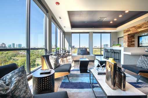 a living room filled with furniture and a large window