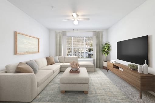 a living room with a large couch and a flat screen tv