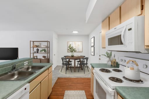a kitchen with green countertops and white appliances