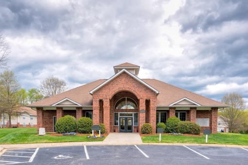 Parking Lot and Walkway in Front of Leasing Office Surrounded by Shrubs