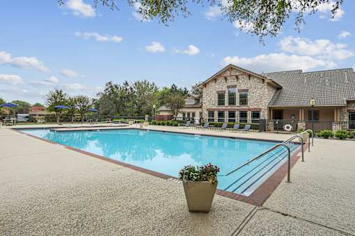 A pool with a building behind it.