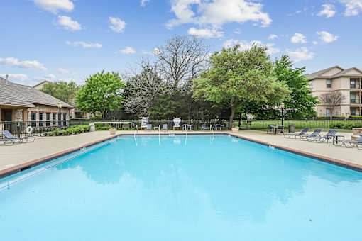A large swimming pool in a sunny outdoor setting.