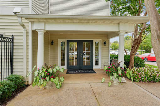 A white house with a black gate and a black door.