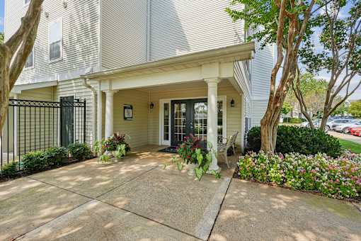 A house with a front porch and a black gate.
