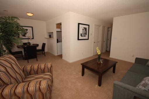 a living room with a couch and a chair and a coffee table