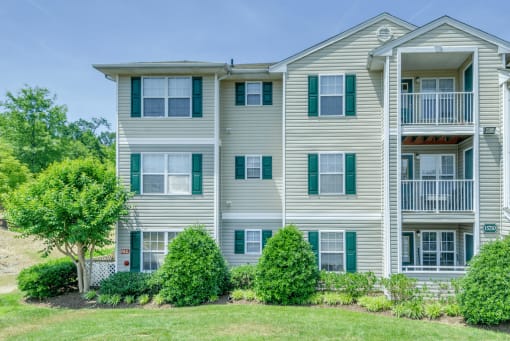 Apartment building exterior surrounded by native landscaping