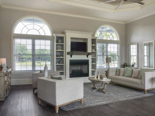 Clubhouse lounge with couches, décor, tables and chairs.