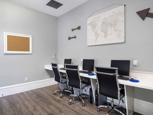 Business center with 3 desktop computers.