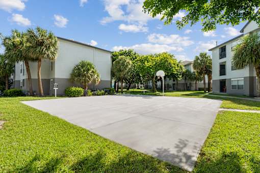 A sunny day at a residential complex with a large open area in the foreground.