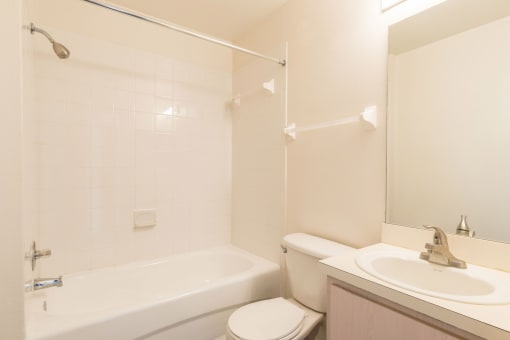 a bathroom with a sink toilet and a bath tub